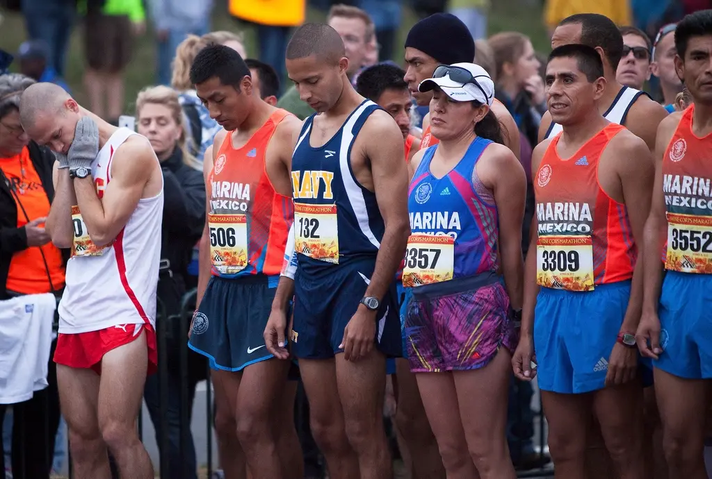 Runners with race bibs at a marathon start line